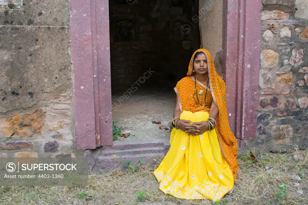Rajasthani Woman in traditional dress in doorway of old building Ranthambhore Rajasthan India