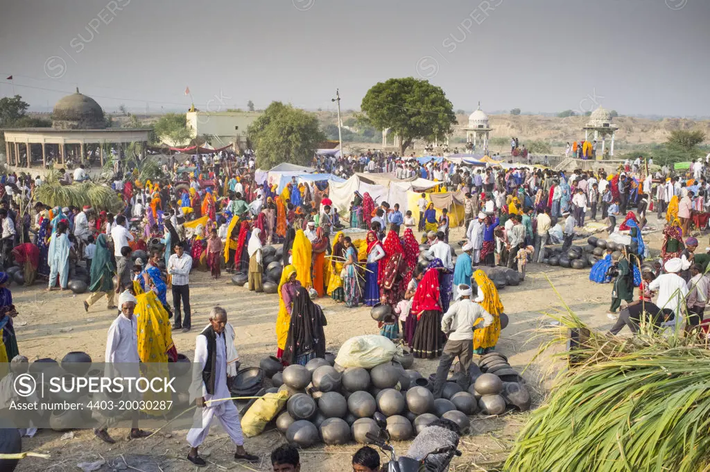 Local market busy with traders selling eathenware water pots and cooking utensils Rajasthan India