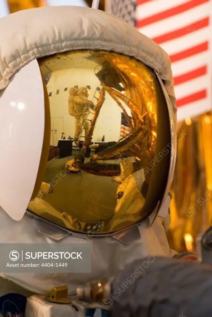 Astronaut descending ladder of Apollo Lunar Module reflected in second astronaut's spacesuit visor