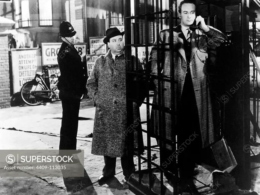 GEORGE SANDERS and ALFRED HITCHCOCK in REBECCA (1940), directed by ALFRED HITCHCOCK.