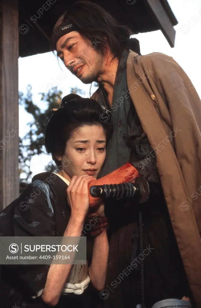 HIROYUKI SANADA and RIE MIYAZAWA in THE TWILIGHT SAMURAI (2002) -Original title: TASOGARE SEIBEI-, directed by YOJI YAMADA.