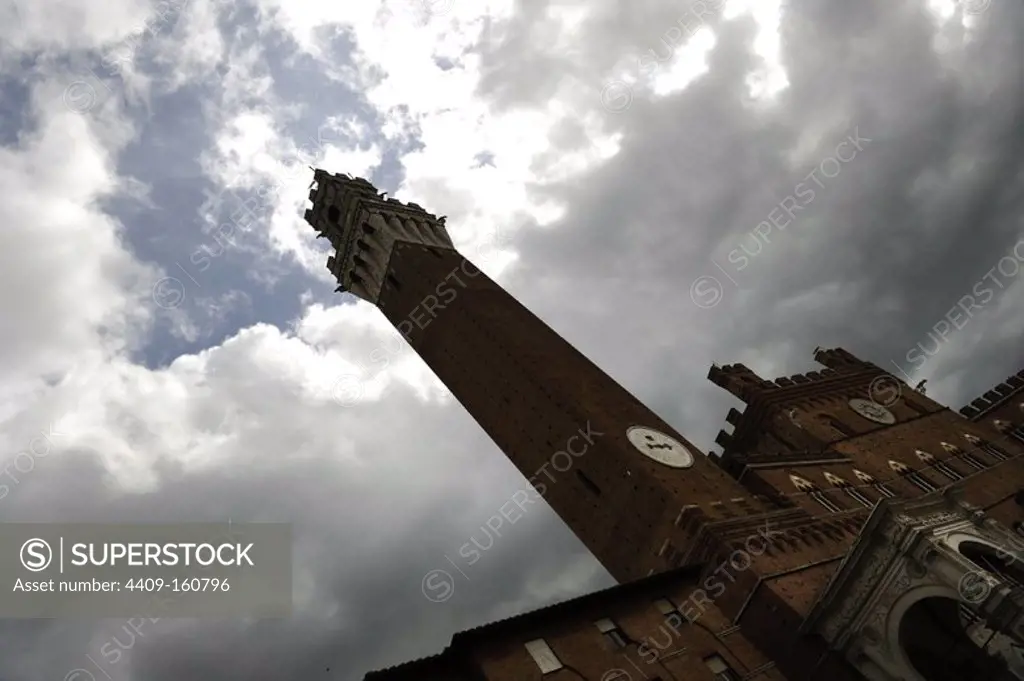 Italy. Siena. Mangia Tower, adjacent to the Town Hall. Medieval, 14th century. 88 metres. Piazza del Campo,.