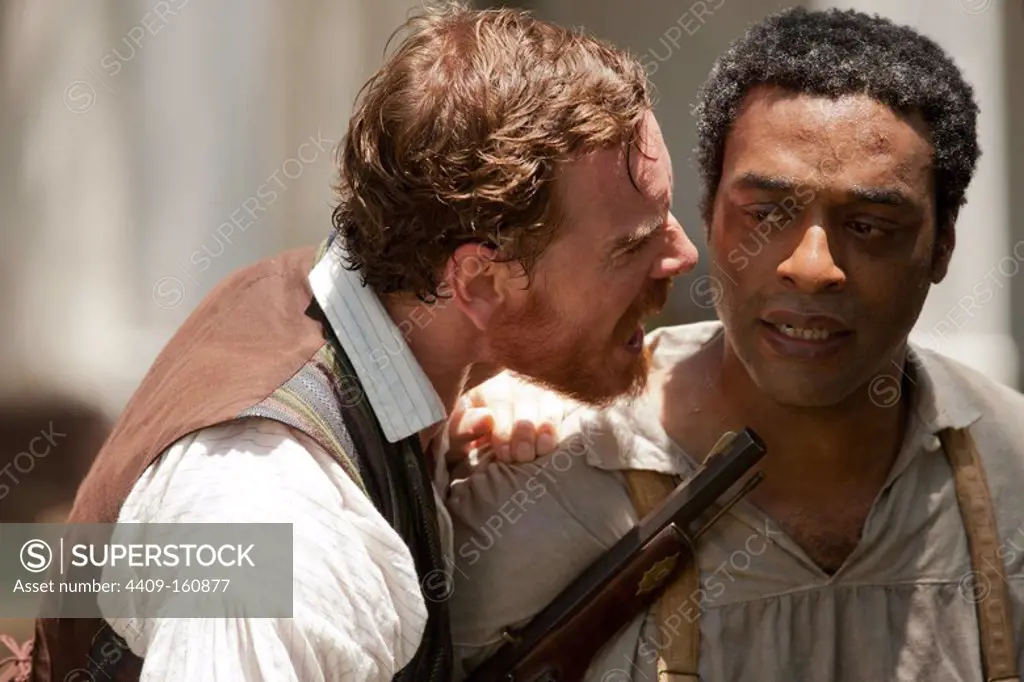 CHIWETEL EJIOFOR and MICHAEL FASSBENDER in 12 YEARS A SLAVE (2013), directed by STEVEN R. MCQUEEN.