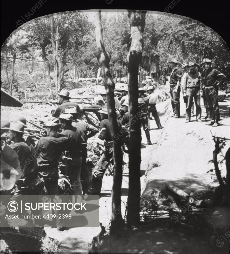 Spanish American War. 14th Regulars fighting from captured Filipino trenches in woods near Passay, Phillippine Islands.