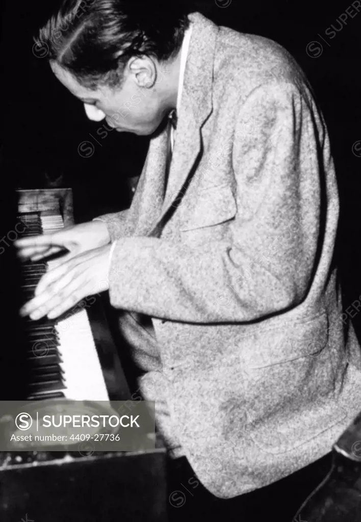 Jazz musician Horace Silver looking down at the keyboard while playing a piano, 1955.
