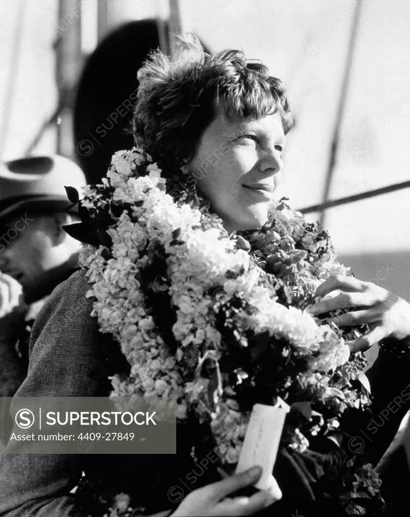 Amelia Earhart, world famous aviatrix arrives via ship at Honolulu. She was leis upon arrival.