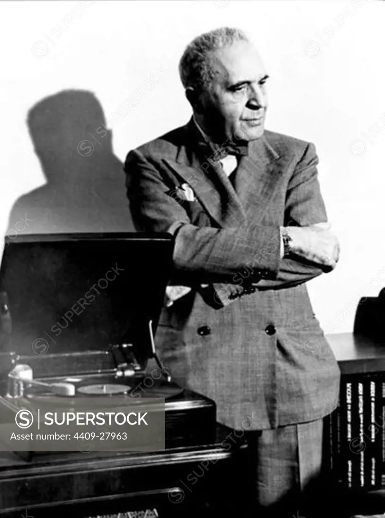 American conductor and pianist Bruno Walter (1876-1962), an authority on the works of Mozart and Mahler, standing, listening to a phonograph recording.