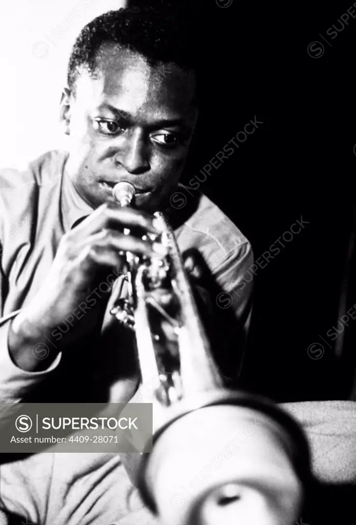 Miles Davis playing trumpet.