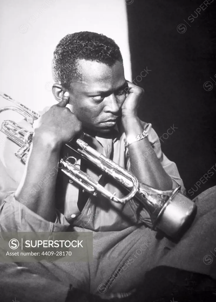 Jazz trumpeter Miles Davis poses for a portrait early in his career playing his horn in circa 1955 in New York City.
