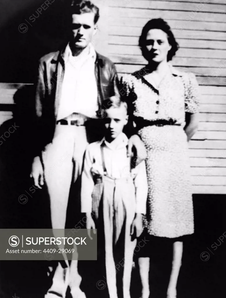 The American singer Elvis Presley and his parents outside his childhood home in Tupelo, Mississippi, in 1945.