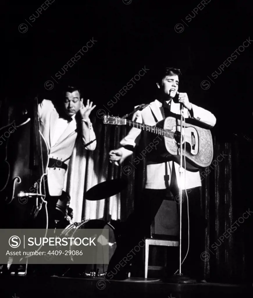 The American singer Elvis Presley performing with his bassist, Bill Black, during the 50's.