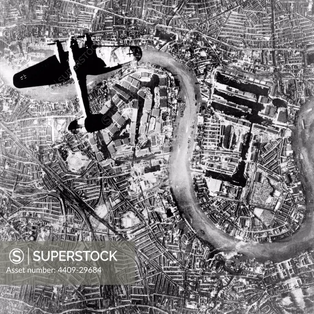 An aerial view of a German Heinkel III bomber flying over the River Thames in London, England, during WWII.