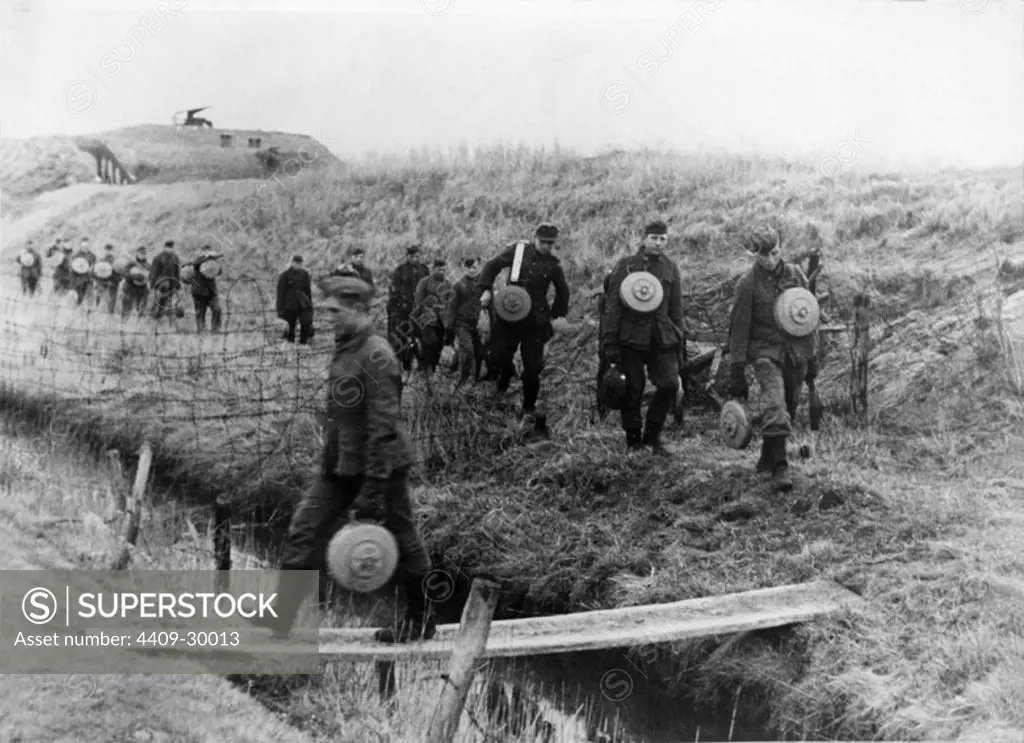 German soldiers with mines going to an area that has to be mined.