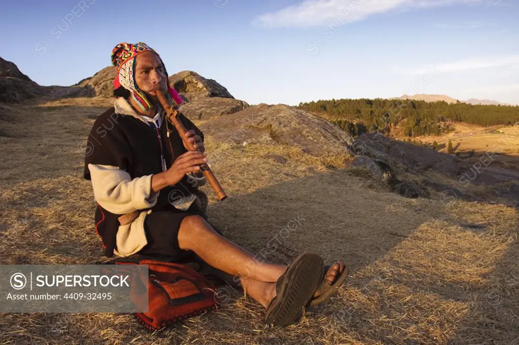 Flautist in the ruins of Sacsayhuaman. Cusco City. Sacred Valley. Cusco Departament. Peru.