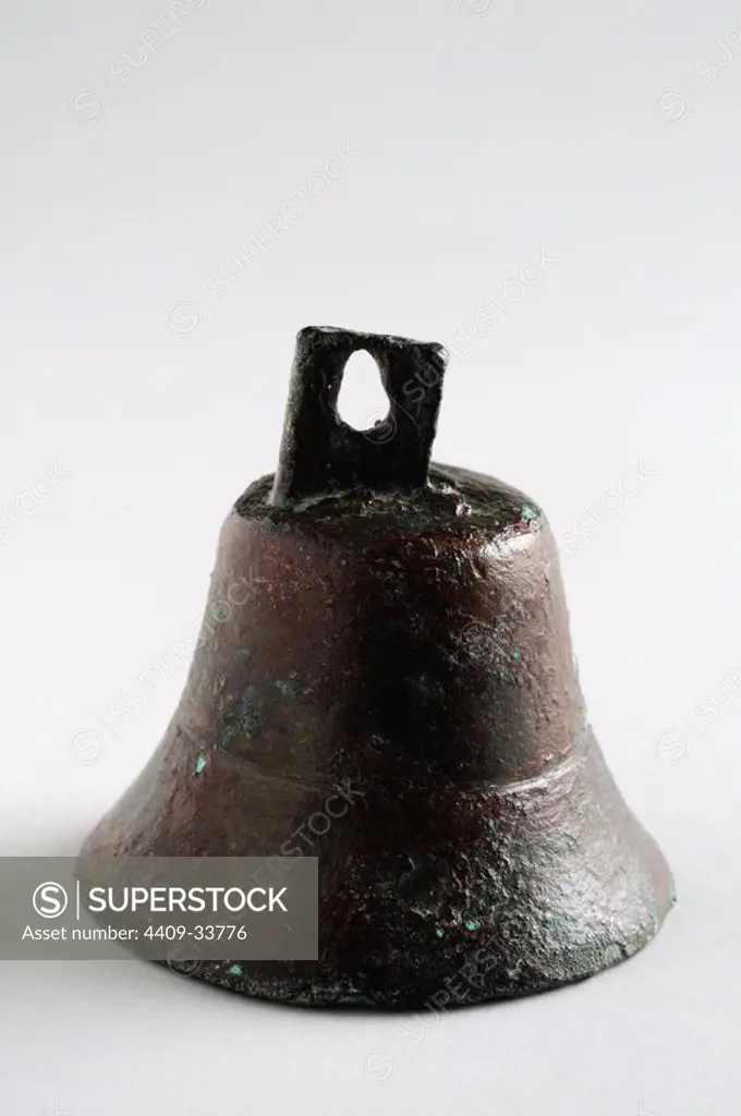 Bronze bell with conical body shape and hook at the top. Height 42 mm Width 35 mm Thickness 2 mm Weight 39, 7 gr (1 St - 2 nd CE )- Roman period, from the archaeological site of Complutum in Alcalá de Henares ( Madrid ). SPAIN.