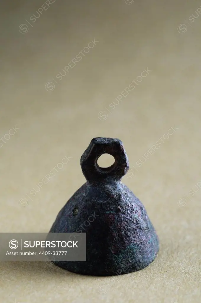 Pendant of a bronze bell . Diameter 1.5 cm High 1, 6 cm. ( 1 St - 3 rd CE ) - Roman period, from the " House of Hyppolytus "- Archaeological site of Complutum in Alcalá de Henares ( Madrid ). SPAIN.