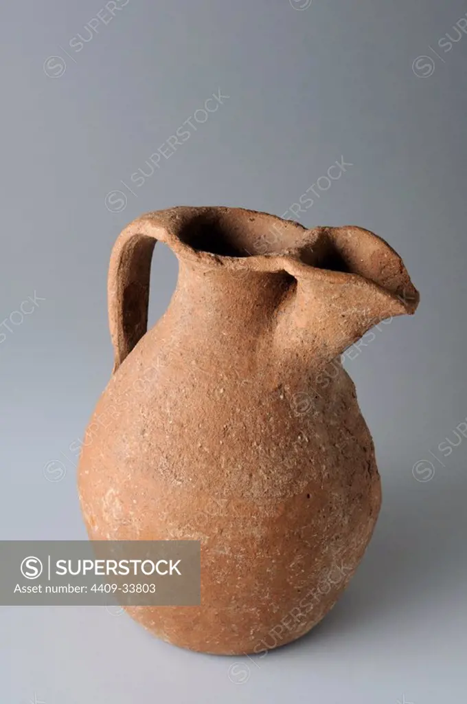 Ceramic jar with globular body with a handle and spout. 11.8 x 8, 7 cm (7 th CE ) - Visigoth period from the "Afflicted Necropolis - Villa del Val" - Archaeological site of Complutum in Alcalá de Henares ( Madrid ). SPAIN.