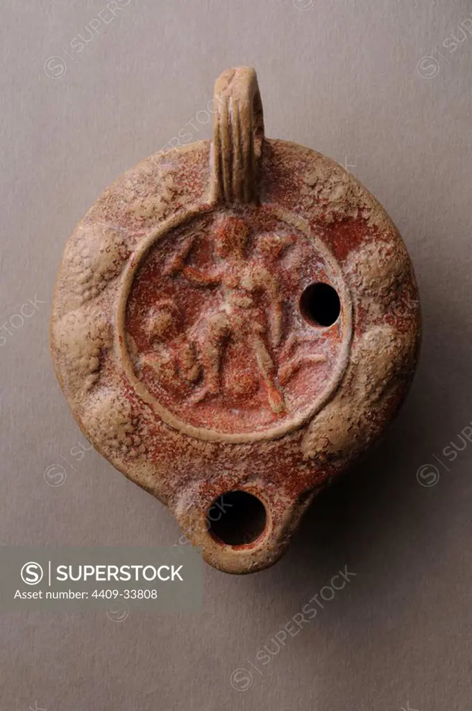 Disc oil- Lamp decorated with gladiatorial fight scene and bunch of grapes. 10 cms x 7.8 cms ( 2nd - 3rd CE ) - Roman period , from the archaeological site of Complutum in Alcala de Henares ( Madrid ). SPAIN.