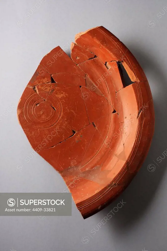 Ceramic plate Hispanic imitation African " Terra Sigillata ". Rim diameter 270 mm Base diameter 64 mm Height 42 mm ( 5 th CE )- Roman period , from the "Villa del Val" - Archaeological site of Complutum in Alcalá de Henares (Madrid). SPAIN.