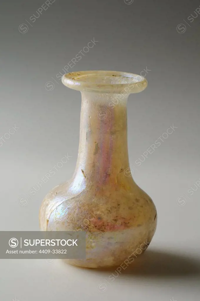 Unguent bottle air blown glass. Height 59 mm Thickness 2 mm ( 5th CE ) Roman period, from the " Western Necropolis - Archaeological site of Complutum in Alcalá de Henares ( Madrid ). SPAIN.
