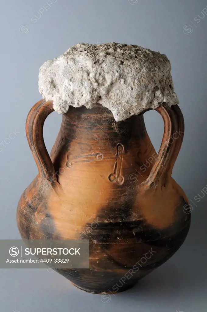 Ceramic vessel " Terra Sigillata" brilliant decorated with phallic amulets print and sealed with lime mortar. ( 3 rd CE ) - Roman period, from" House of Griffins "- Archaeological site of Complutum in Alcalá de Henares (Madrid). SPAIN.