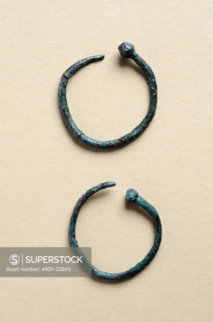 Two earrings circular bronze decorated with ball end . Diameter 2, 5 cm Thickness 0, 4 cm.( 1 st - 3 rd CE ) - Roman period, from the " House of Hyppolytus "- Archaeological site of Complutum in Alcalá de Henares ( Madrid ). SPAIN.