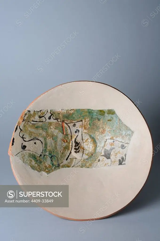 Glazed ceramic dish with floral decoration. Base diameter 68mm Maximum width 237 mm Thickness 7 mm ( 14 th CE ) - Medieval period belonging of the " Burgo de Santiuste Museum" in Alcalá de Henares. (Madrid). SPAIN.