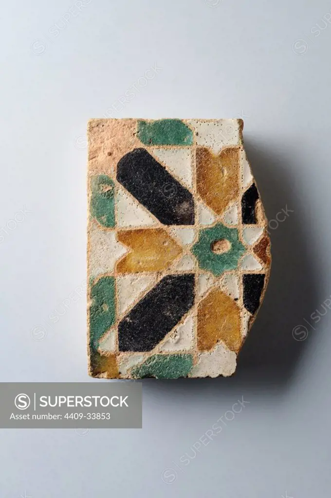 Glazed ceramic tile with geometric decoration 10 x 9, 5 cm. (15 th CE ) - Modern era belonging of the " Burgo de Santiuste Museum" in Alcalá de Henares. (Madrid). SPAIN.