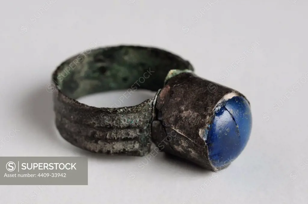 Silver ring decorated with blue glass paste crimp.Length 1, 2 cm Diameter 0, 8 cm. (1st - 5 th CE ) - Roman period, from the " Villa del Val" - Archaeological site of Complutum in Alcalá de Henares ( Madrid ). SPAIN.