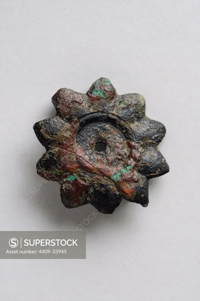 Bronze fibula in the form of ten-pointed star with inner circle.Diameter 2, 6 cm thickness 0, 15 cm.