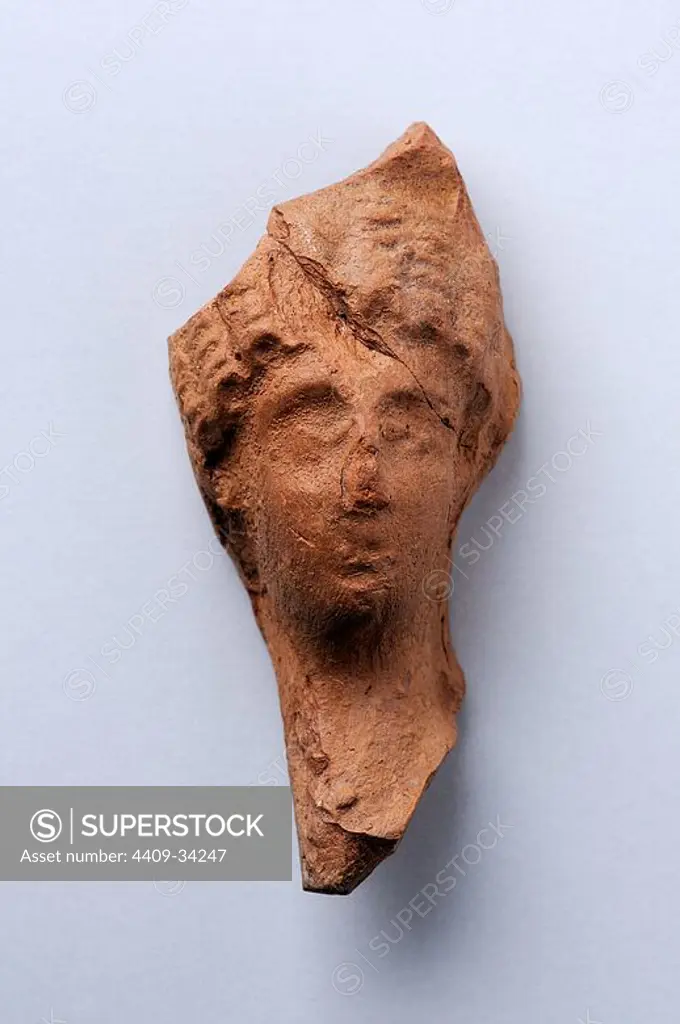 Head female terracotta figurine loops Roman hairstyle. Height 6, 7 cm Width 3, 1 cm. (1 st - 3 rd CE ) - Roman period, from " House of Griffins "- Archaeological site of Complutum in Alcalá de Henares ( Madrid ). SPAIN.