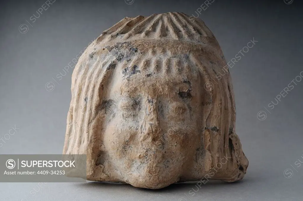 Antefixes of terracotta representing female head with short hair and bulky on the front. Height 13, 3 cm Width 14 ,1 cm. (1 st - 3 rd CE ) - Roman period from archaeological site of Complutum in Alcalá de Henares ( Madrid ). SPAIN.