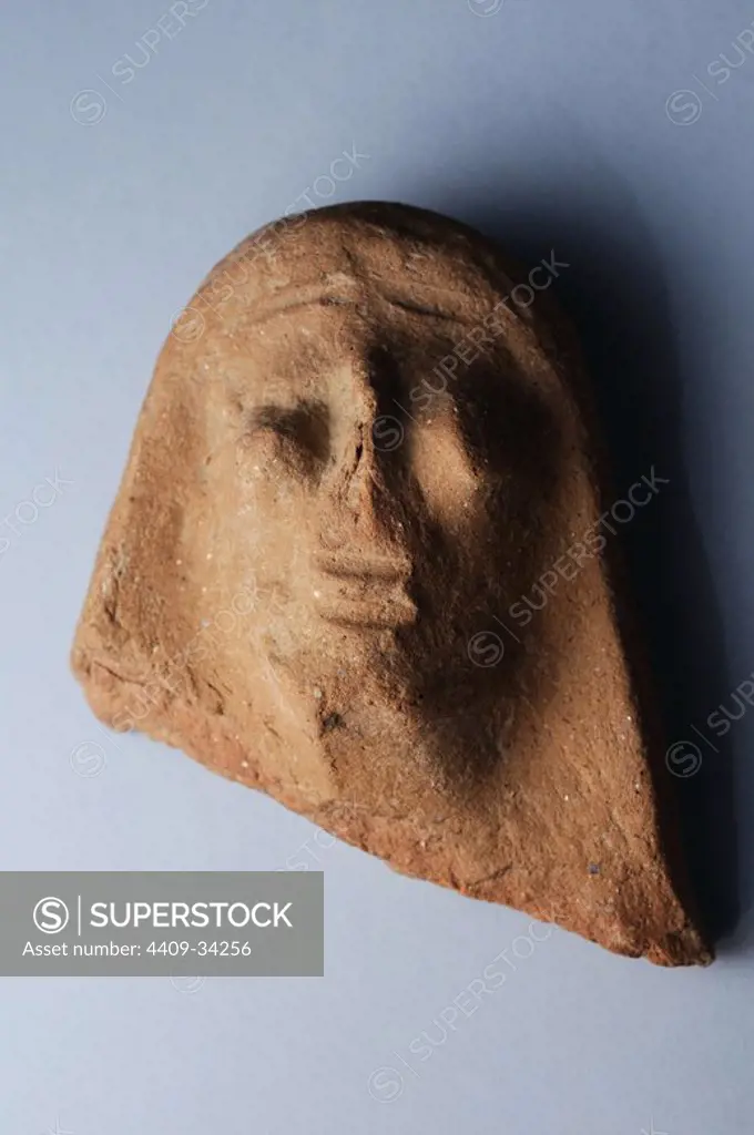 Antefixes of terracotta representing male head anthropomorphic primitive and highlighted eyes. Height 8 cm Width 6,6 cm Weight 3, 4 cm ( 1st CE ) Roman period, from the " Basilica " - Archaeological site of Complutum in Alcalá de Henares ( Madrid ). SPAIN.
