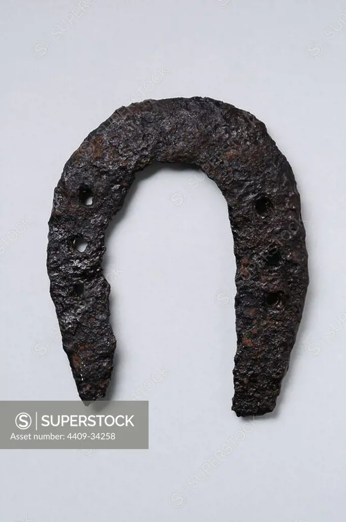Iron horseshoe .Height 120 mm Thickness 4 mm. ( 4th- 8th CE ) - Roman period, from the " South Baths "- Archaeological site of Complutum in Alcalá de Henares ( Madrid ). SPAIN.
