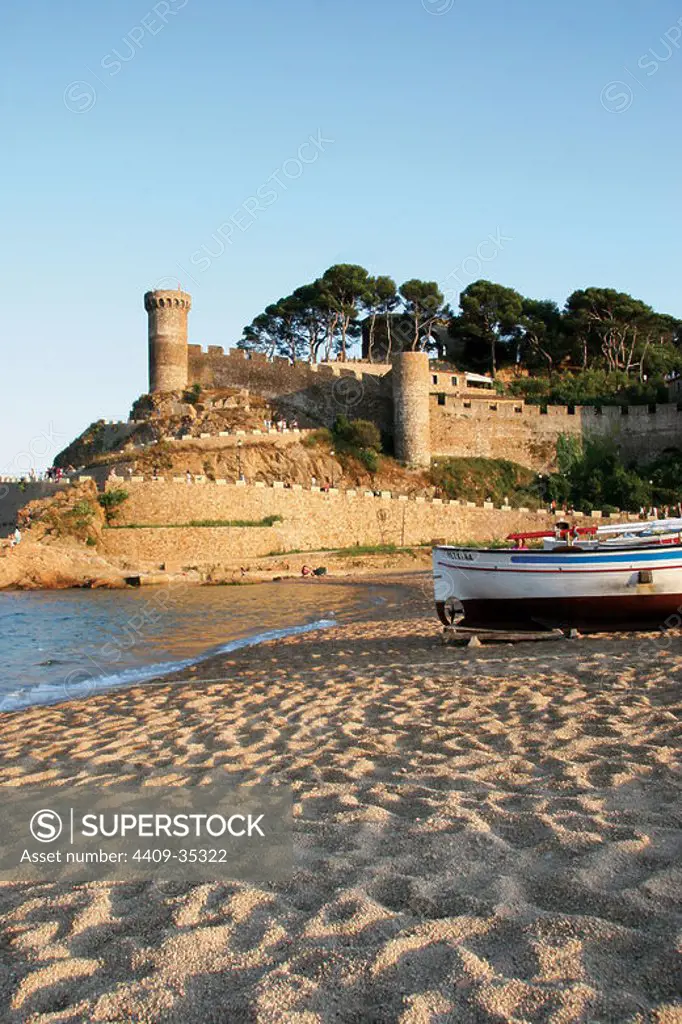 TOSSA DE MAR. Town located in the Costa Brava. Landscape coast. Fishing boat in the sand beach. La Selva Region. Girona Province. Catalonia. Spain. Europe.