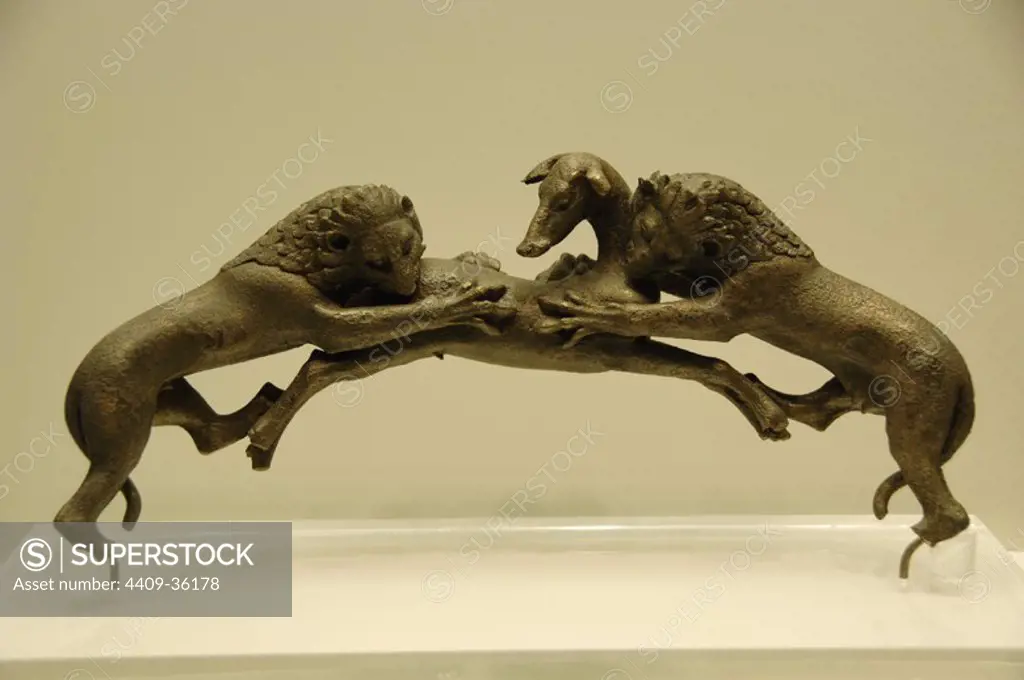 Greek Art. 5th century B.C. Greece. Bronze bath handle depicting two lions devouring a deer (c. 480 BC). Archaeological Museum of Olympia.