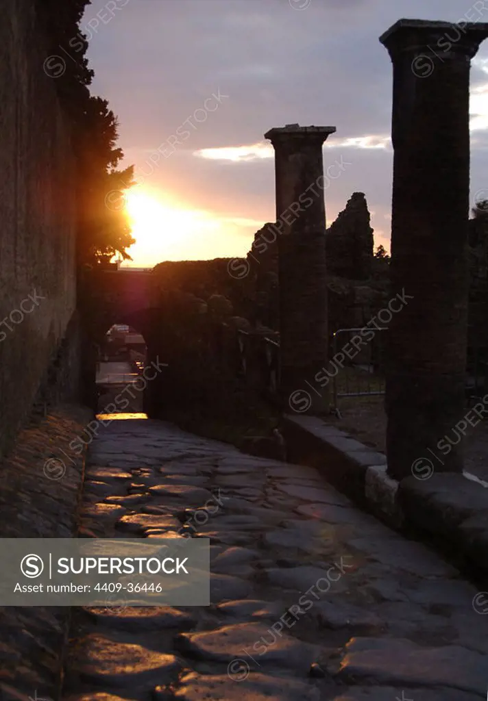 Italy. Pompeii. Sunset on a cobbled street.