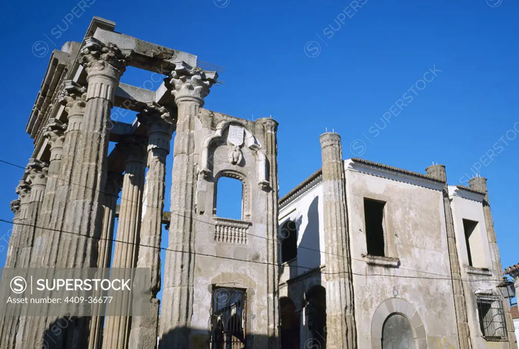 Roman Art. Temple of Diana. Eastern side. Corinthian style, most notably the Renaissance window with the Corbos' family coat of arms. After the temple, the Palace of the Count of Corbos. Merida. Extremadura. Spain.