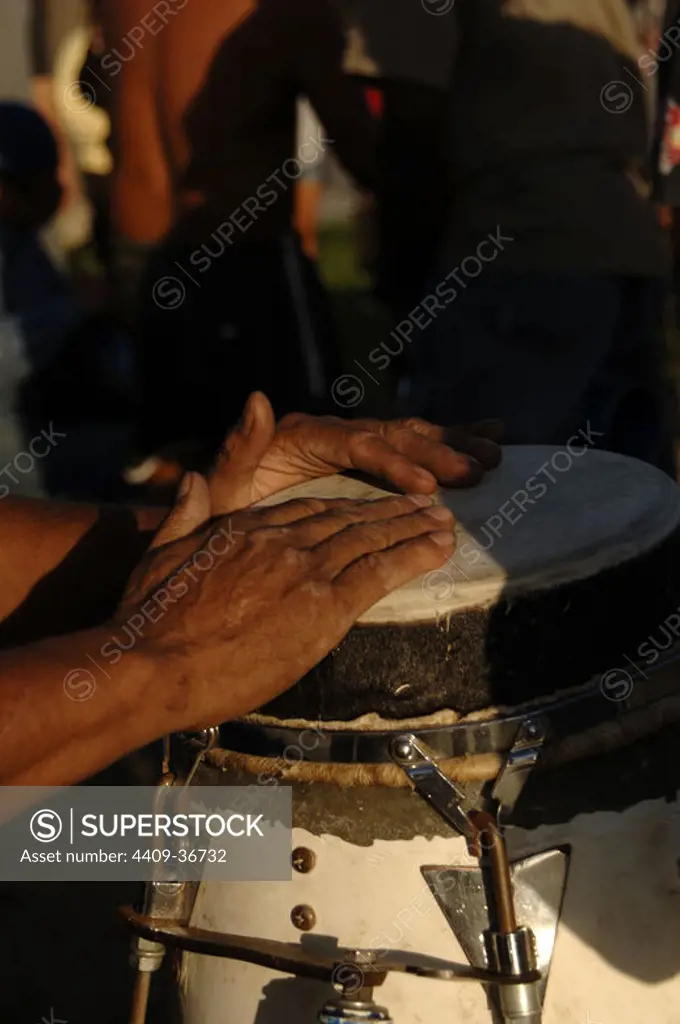 Man playing bongo drum. USA.