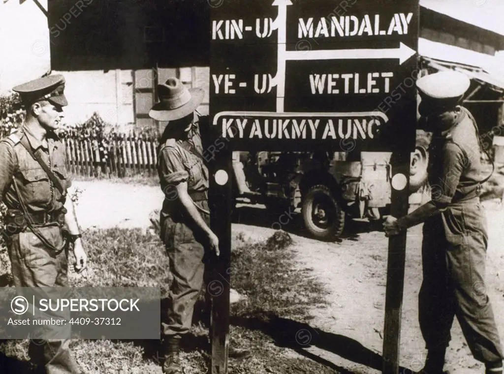 WORLD WAR II. Members of the British army installing a sign showing the direction of Mandalay (Burma), that was destroyed by British bombing during the Japanese ccupation (1942-45).