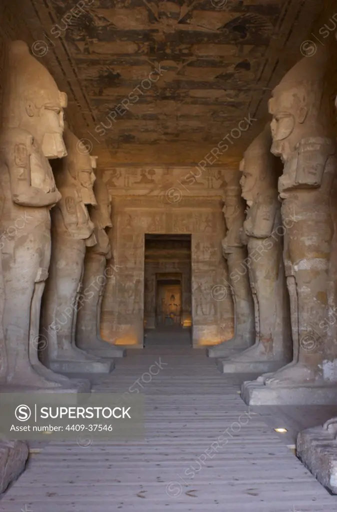 Egyptian art. Great Temple of Ramses II (1290-1224 BC). Funerary temple carved in the rock. View from inside the first room, with eight statues of Ramses II as the god Osiris. Abu Simbel. Egypt.