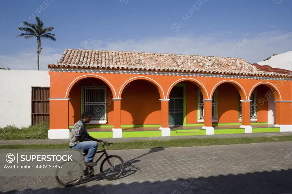 Mexico. Tlacotalpan. man on a bike along a street in the historic city center. Veracruz State.