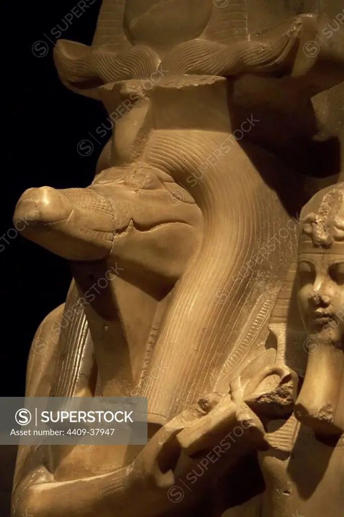 Statue of Amenhotep III (Neb-Maat-Ra) and Sobek c.1390-1352 BC. Carved from Calcite (Egyptian Alabaster). Found in the Sobek temple at Dahamsha. Sobek is seated in a human form with the crocodile head and his right hand holds the Ankh giving life to the youthful Amenhotep III. The King is wearing the Nemes headdress, with the uraeus and royal beard. 18th Dynasty. New Kingdom. Luxor Museum. Egypt.