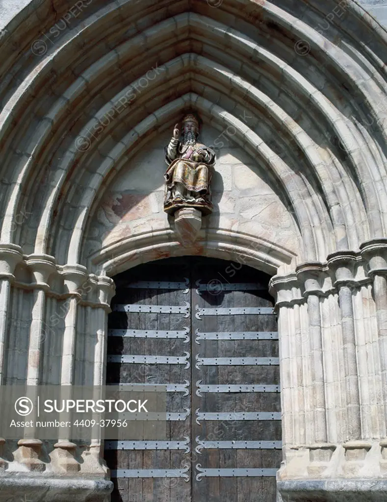 Gothic art. Spain. Church of St. John the Baptist. Door with archeries of pointed archs and seated sculpture of a saint in the tympanum. Mondragon. Province of Guipuzcoa. Basque Country.