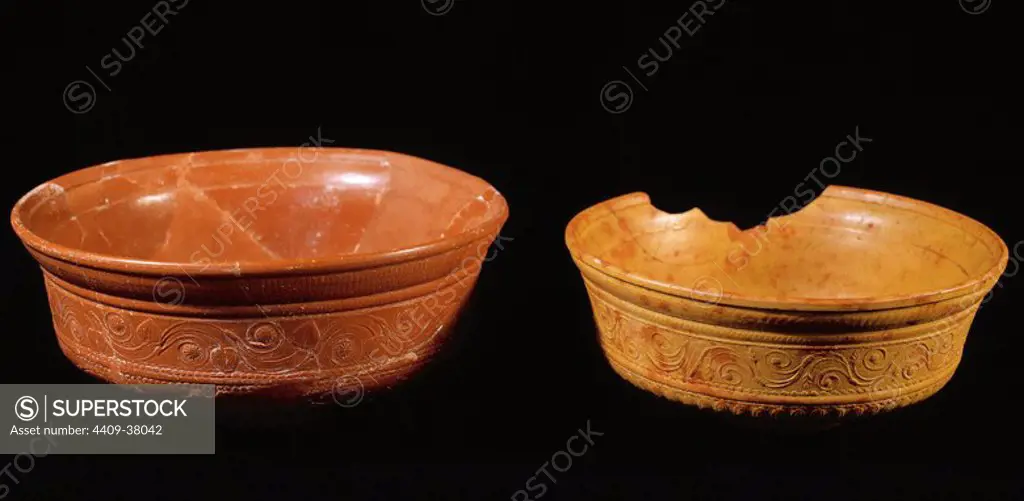 Roman Art. Terra Sigillata. Two roman red gloss terra sigillata bowl with relief decoration. The ceramic orange is hispanic terra sigillata. 1st-5th centuries. National Museum of Art. Merida. Spain.