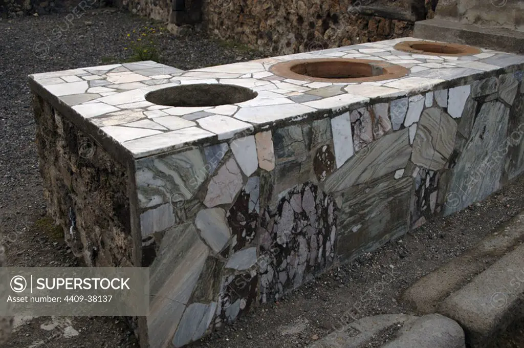 Italy. Pompeii. Marble covered counter Thermopolium. Campania.