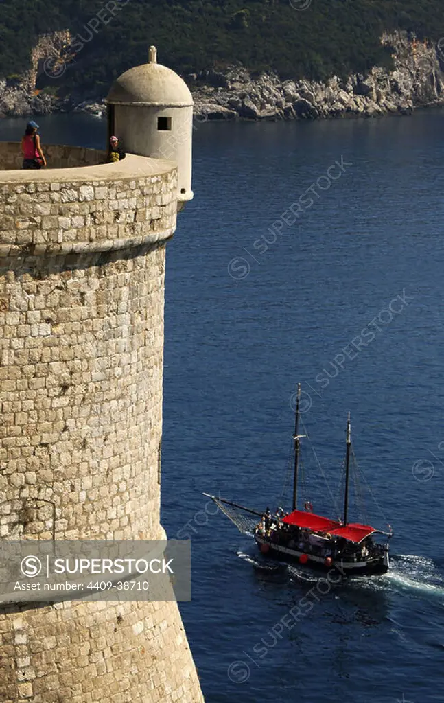 Sailboat sailing in Adriatic Sea, near the wall of Dubrovnik. Croatia.