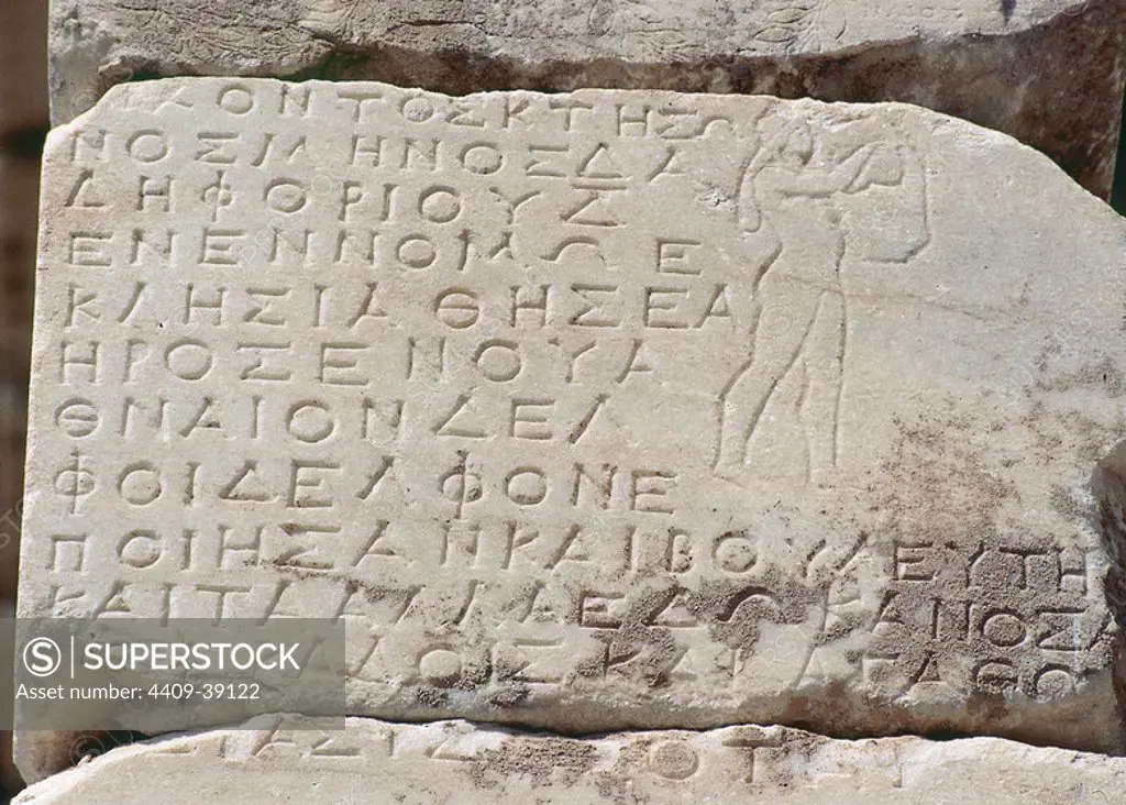 Treasury of the Athenians. Temple built around 5th century BC. Detail of a hymn to Delphi, in ancient Greek, engraved in a wall. Apollo also appears with the zither. Delphi. Greece.