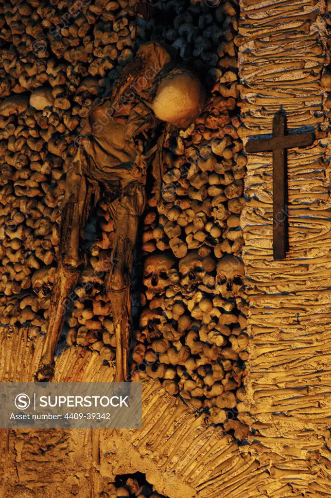 Portugal. Evora. Chapel of Bones. Chapel located next to the entrance of the Church of St. Francis. The interior walls are covered with human skulls and bones.16th century. Skeleton hanging from chains.