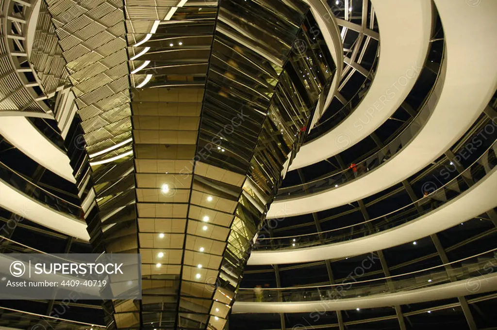 Dome of the Reichstag, seat of the German Parliament, designed by Norman Foster (b.1935). Interior. Night. Berlin. Germany.